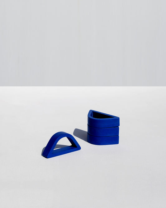 Set of four cobalt arched napkin rings handcrafted by Alkaline Shop, perfect for elegant table settings and modern dining decor